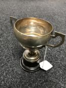 A silver twin handled trophy on stand