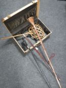 A vintage case containing a carpet beater, brass and copper horn,
