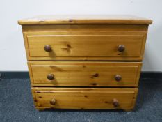 A pine three drawer chest