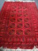 A Bokhara rug on red ground