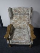 A blonde oak framed wing back armchair