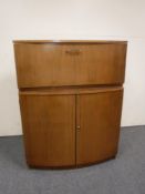 A 20th century walnut cocktail cabinet