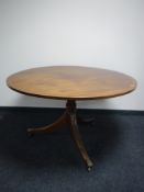 A circular inlaid mahogany Regency style dining table