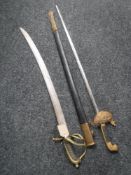 A naval style sword in sheath and an Indian sword CONDITION REPORT: These are both