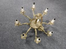A continental gilt metal eight way light fitting