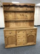 A stripped pine kitchen dresser
