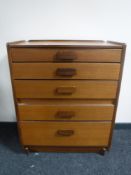 A mid 20th century teak five drawer chest retailed by White & Newton Ltd