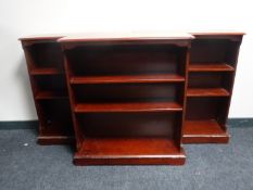 Three sets of mahogany open bookshelves