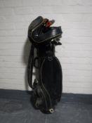 A Wilson golf bag containing irons and drivers