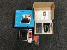 A basket of Amazon Echo Show,30 two tracking devices,