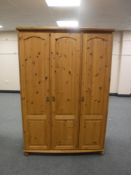 A pine triple door wardrobe