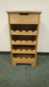 A contemporary light oak bottle rack, width 45.