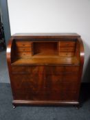 An early 20th century barrel fronted bureau
