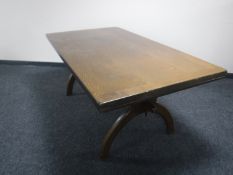 An oak refectory pull out table on X frame support