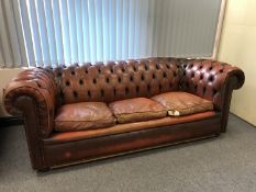 A brown button leather Chesterfield three seater settee