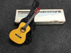 A boxed Yamaha Portatone PS-55 keyboard in box and an acoustic guitar in carry bag