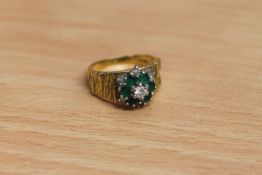 An 18ct gold emerald and diamond cluster ring, size L.
