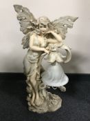 An ornate cherub table lamp