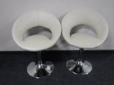 A pair of cream leather bar stools