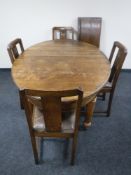 An Edwardian oak extending oval table, two leaves,