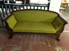 An early twentieth century scroll arm mahogany settee