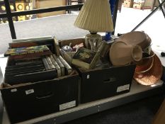 Two boxes of books, tins, china, ornaments, crystal, table lamps etc.