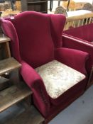 A continental button wing armchair in Burgundy fabric