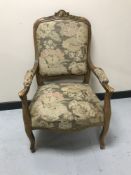 A continental carved light oak armchair