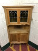 A light oak corner cabinet