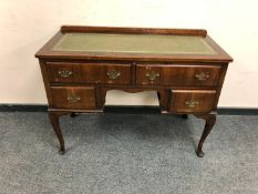 A late nineteenth century mahogany desk fitted with four drawers with green leather top
