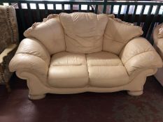 A cream leather three seater and two seater settee.