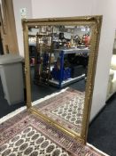 A Victorian style bevelled gilded overmantel mirror