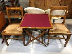 A pair of antique oak chairs together with a folding coaching table