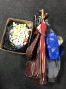 Two golf bags containing clubs, umbrella,