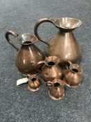 A graduated set of six copper jugs