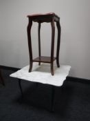 A white marble topped occasional table and a mahogany plant stand