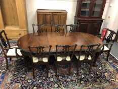 A good quality George III style mahogany extending dining table,