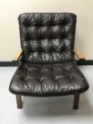 A mid 20th century Scandinavian lounge chair upholstered in brown leather
