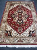 A Heriz carpet, on red ground, 2.3m x 1.