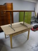 A Formica topped kitchen table with two drawers together with an office table on tubular steel legs