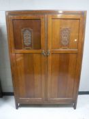 An oak double door wardrobe together with storage drawers