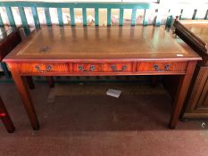A reproduction mahogany leather topped desk
