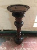 A carved mahogany pedestal
