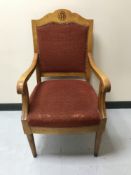 A beech open armchair with monogram