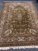 A good quality machine made carpet of Persian Isfahan design, on green ground,