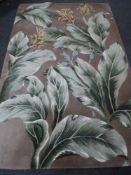 A contemporary carpet with leaf and flower decoration,