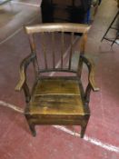 A nineteenth century oak commode chair