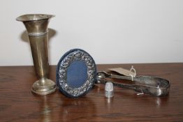 A pair of Newcastle silver sugar tongs, a silver vase,