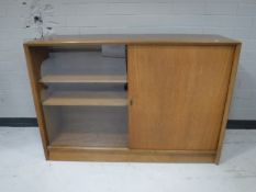 A teak sliding door bookcase