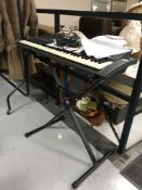 A Yamaha keyboard on stand with lead
